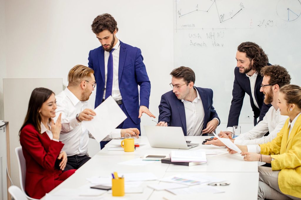 boss in tuxedo and employee, business people gathered in office for discussion, sharing experience and solving problems inside the company